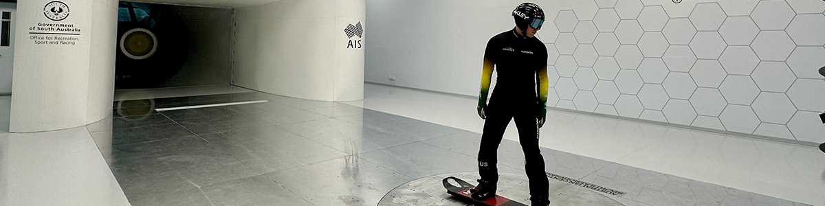 A snowboarder standing in the wind tunnel