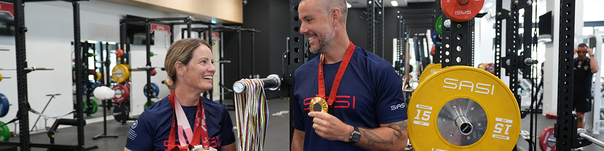 Emily and Jed standing with their gold medals