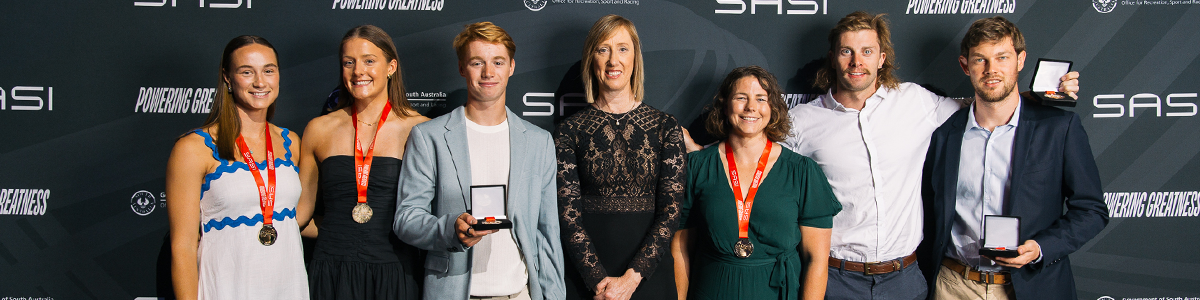 Award recipients standing with their medals