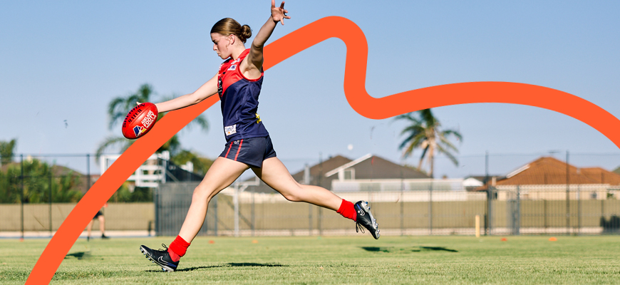 female kicking football
