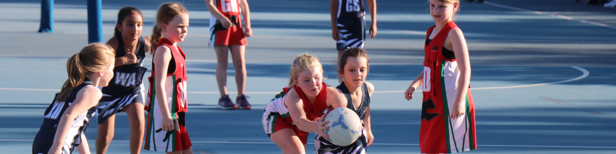 Young netball players on the court